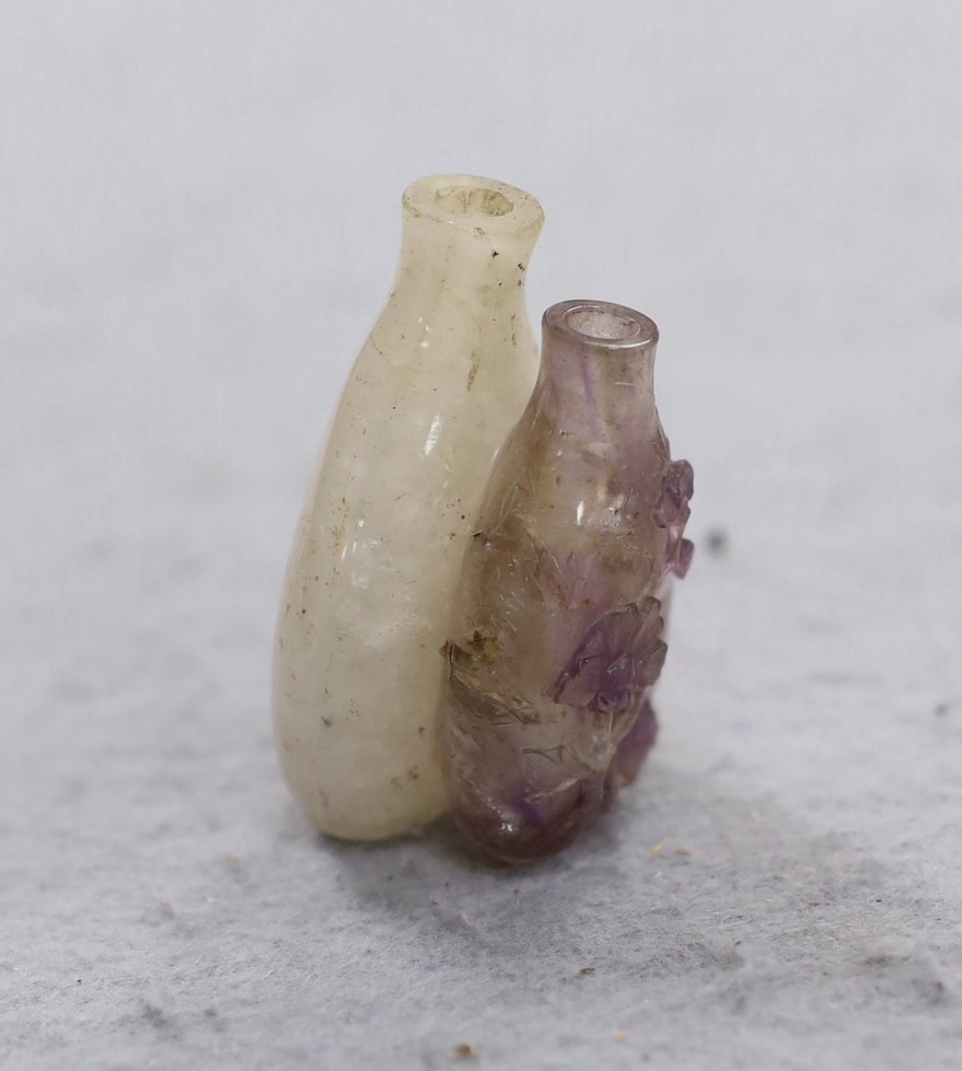 A 19th century Chinese quartz double snuff bottle, 6cm, the carver skilfully incorporating the amethyst crystal inclusions to the relief carving of the front bottle